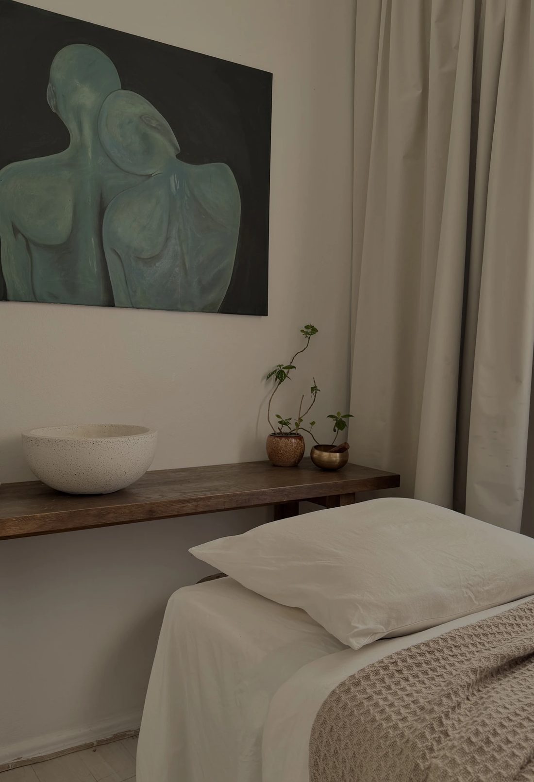Private Studio A treatment room in Bondi Beach, featuring an original painting by Anissa and a calm treatment space.